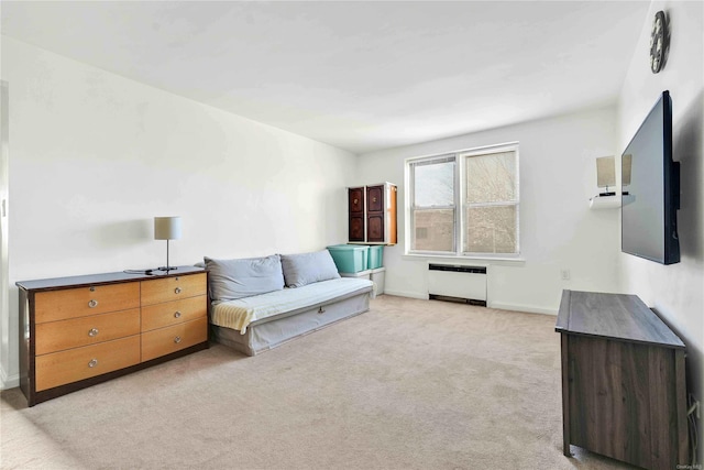 sitting room featuring radiator and light colored carpet