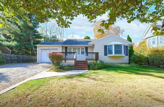 view of front of property with a garage and a front lawn