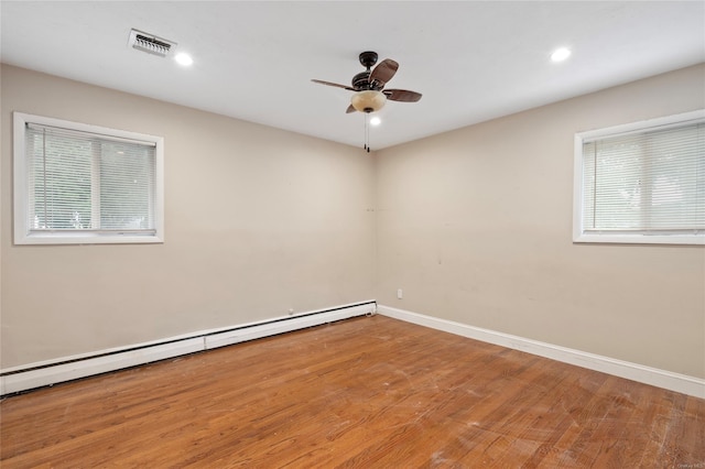 unfurnished room with ceiling fan, hardwood / wood-style floors, and a baseboard radiator