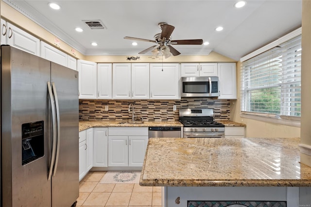 kitchen with decorative backsplash, white cabinetry, and stainless steel appliances