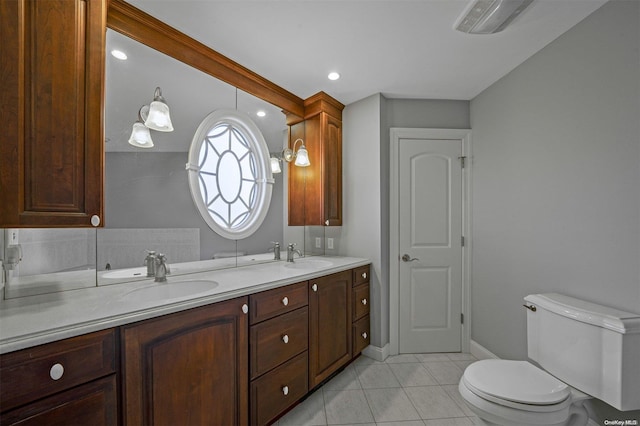 bathroom featuring tile patterned flooring, vanity, and toilet