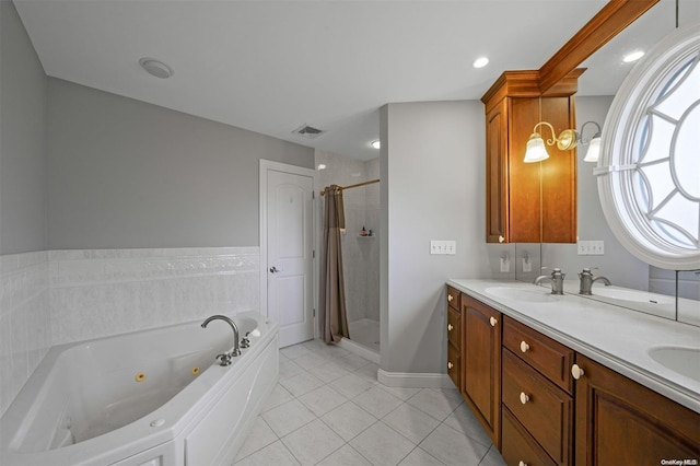 bathroom featuring vanity, tile patterned flooring, and separate shower and tub