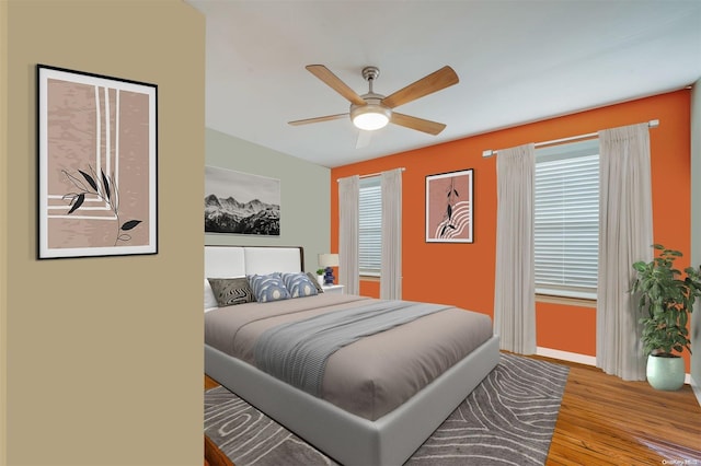 bedroom with ceiling fan and light hardwood / wood-style floors