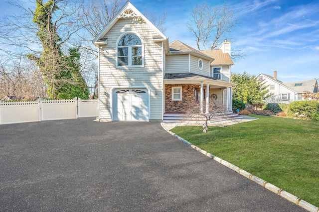 view of front of property with a garage and a front yard