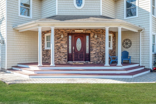 view of exterior entry with covered porch