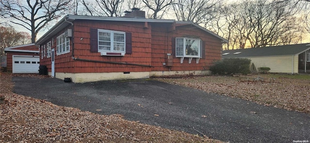 property exterior at dusk featuring a garage