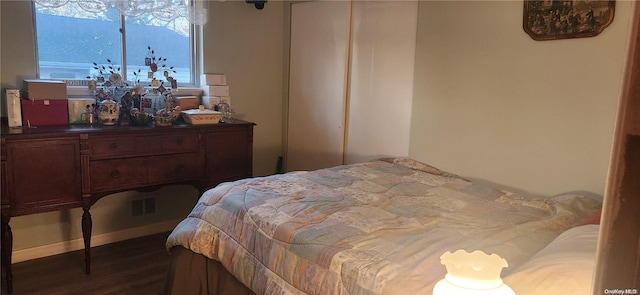 bedroom with dark wood-type flooring