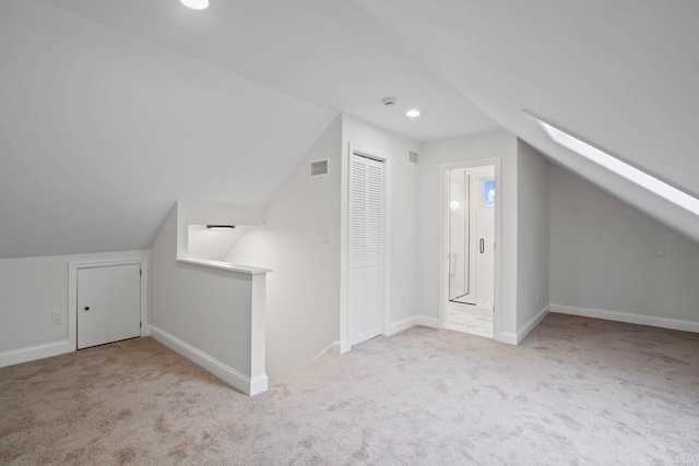 bonus room with visible vents, lofted ceiling with skylight, recessed lighting, carpet floors, and baseboards