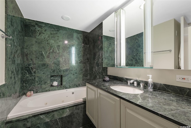 bathroom featuring vanity and tile walls