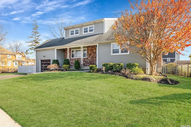 view of front of house featuring a front yard and a garage