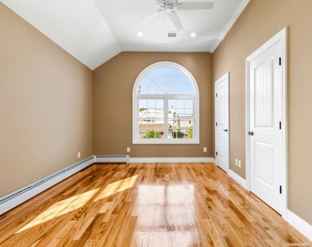 unfurnished room with vaulted ceiling, light hardwood / wood-style floors, baseboard heating, and ceiling fan