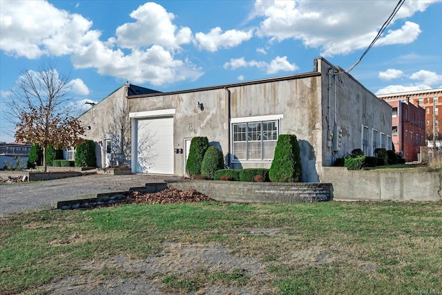 view of front of house with a garage and a front lawn