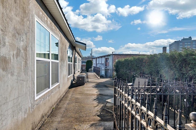 view of side of property with central air condition unit