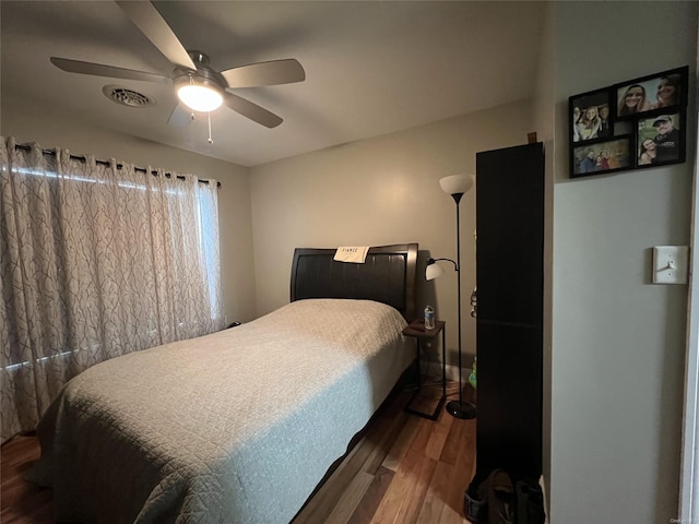 bedroom featuring ceiling fan and dark hardwood / wood-style flooring