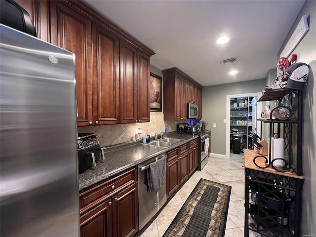 kitchen featuring sink, decorative backsplash, and appliances with stainless steel finishes