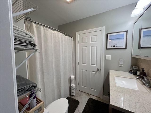 bathroom featuring vanity, toilet, and a shower with shower curtain