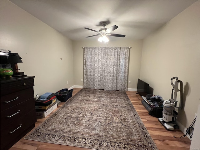 interior space with wood-type flooring and ceiling fan