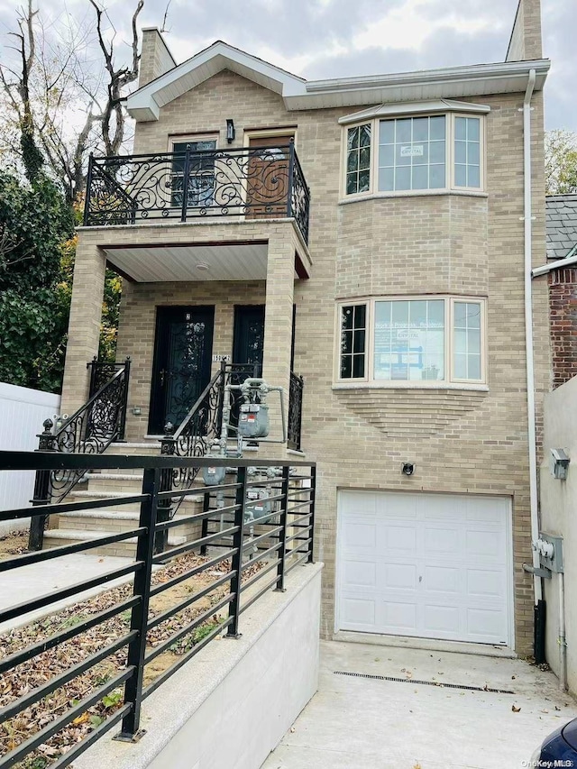 view of front of house featuring a balcony and a garage