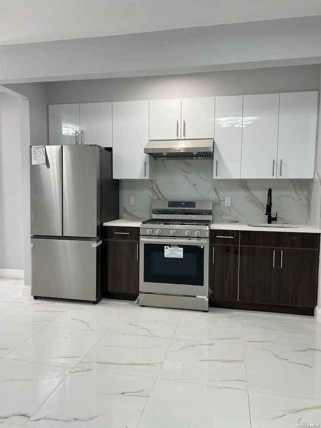 kitchen with backsplash, white cabinets, sink, dark brown cabinets, and stainless steel appliances