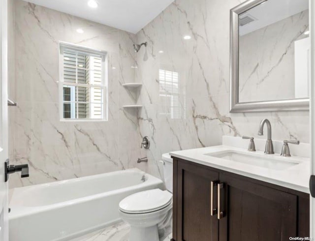 full bathroom with vanity, tiled shower / bath combo, tile walls, and toilet