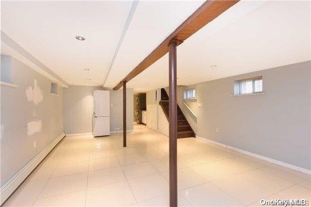 basement featuring a baseboard radiator