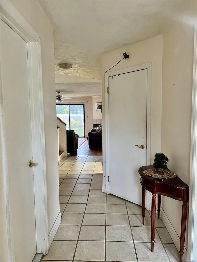 corridor featuring light tile patterned floors