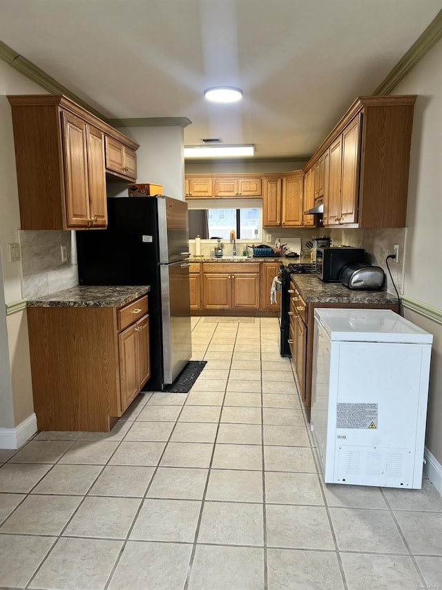 kitchen featuring black gas stove, sink, decorative backsplash, ornamental molding, and light tile patterned flooring