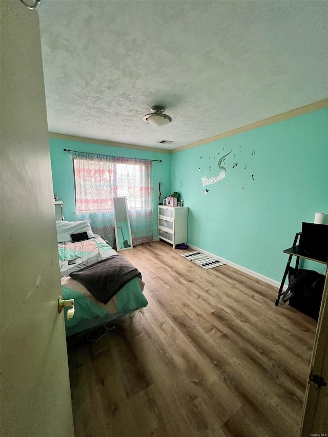 bedroom featuring a textured ceiling and hardwood / wood-style flooring