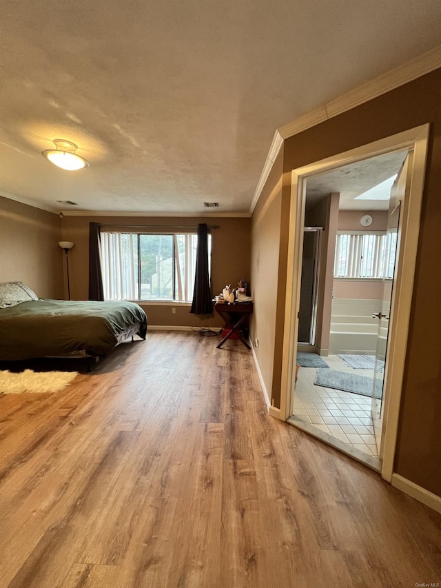 unfurnished bedroom featuring hardwood / wood-style floors, a textured ceiling, and ornamental molding