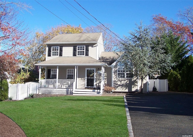 view of front of property featuring covered porch and a front lawn