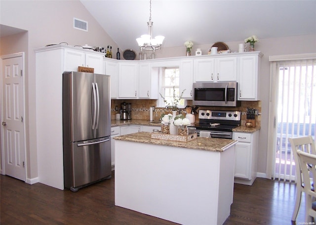 kitchen with white cabinets, decorative light fixtures, a kitchen island, and appliances with stainless steel finishes