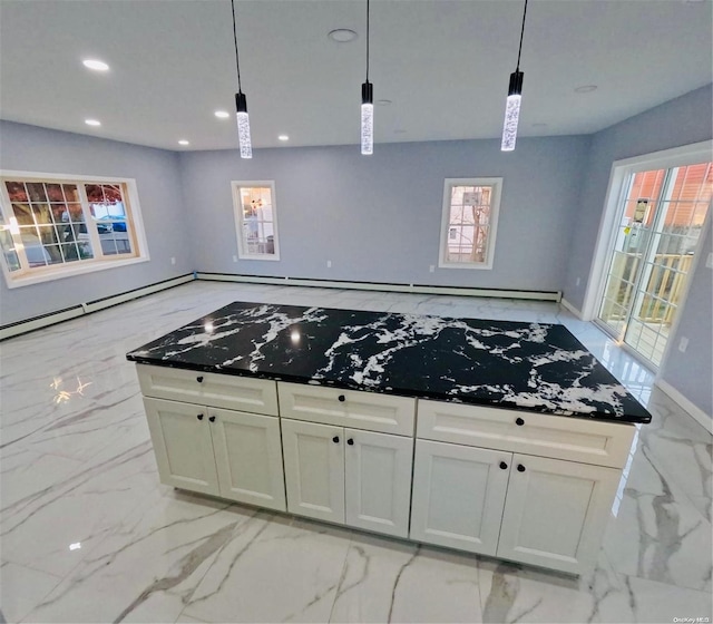 kitchen with white cabinets and decorative light fixtures