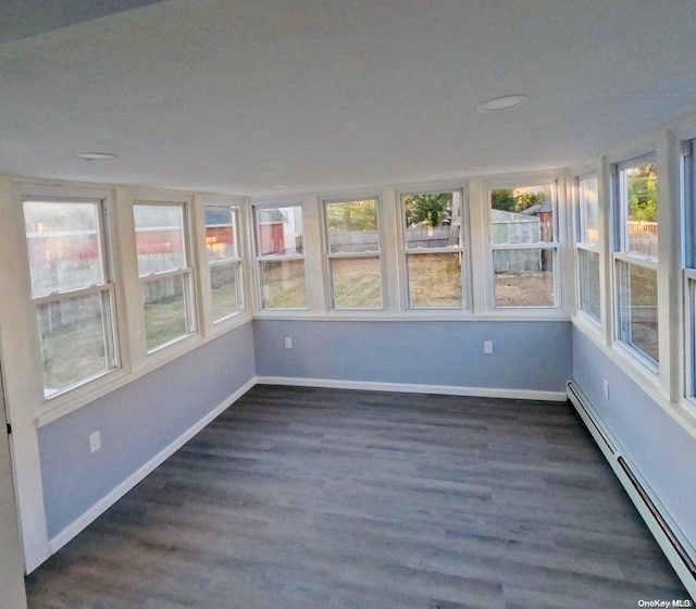 unfurnished sunroom with a baseboard radiator