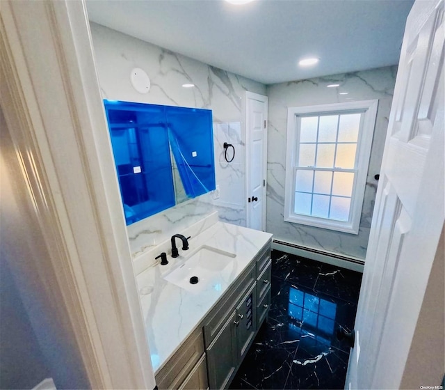 bathroom with vanity and a baseboard heating unit