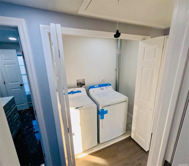 washroom with washer and dryer and dark hardwood / wood-style floors