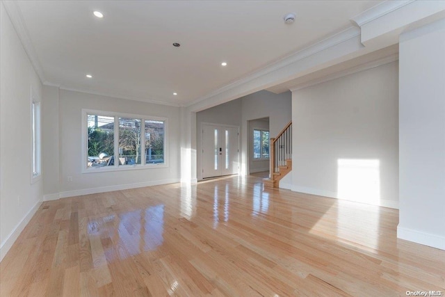 unfurnished living room featuring light hardwood / wood-style floors and ornamental molding