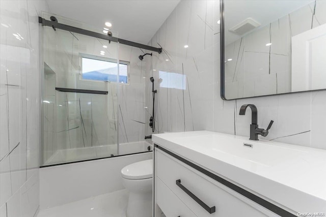 full bathroom featuring backsplash, vanity, tile walls, enclosed tub / shower combo, and toilet