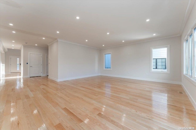 unfurnished room featuring crown molding and light hardwood / wood-style flooring