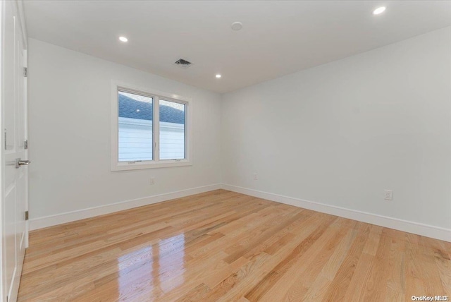 spare room featuring light hardwood / wood-style floors