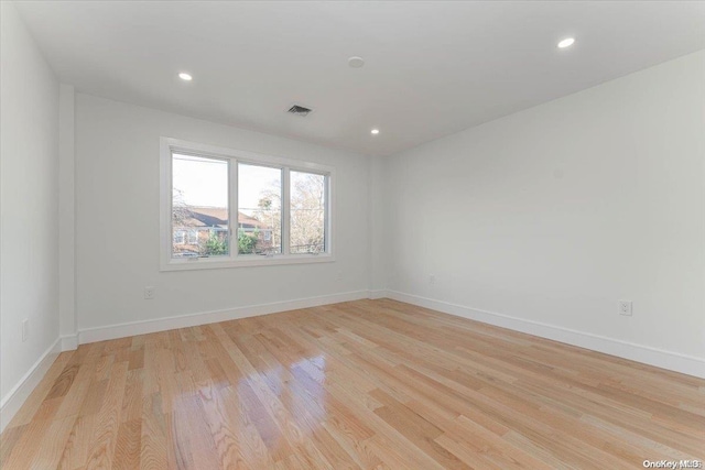 spare room featuring light hardwood / wood-style floors