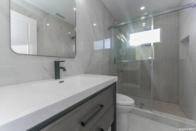 bathroom featuring an enclosed shower, tile walls, and toilet