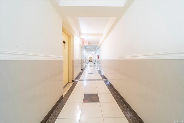 hallway with tile patterned floors