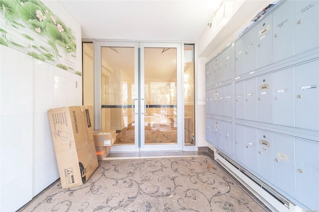 interior space featuring a baseboard radiator and a mail area