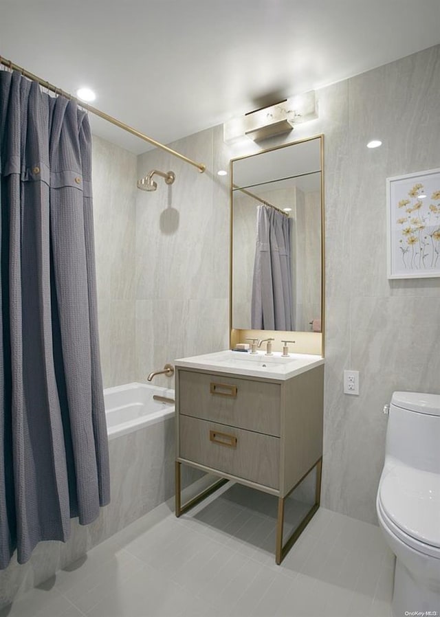 full bathroom featuring shower / tub combo, vanity, tile walls, tile patterned flooring, and toilet