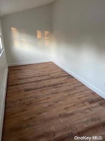 59 Port Washington Ave, Sound Beach, NY 11789 - unfurnished room featuring lofted ceiling, wood finished floors, and baseboards