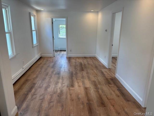 59 Port Washington Ave, Sound Beach, NY 11789 - empty room featuring baseboard heating, wood finished floors, and baseboards