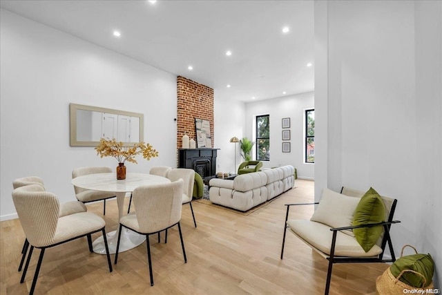 dining room featuring a fireplace and light wood-type flooring