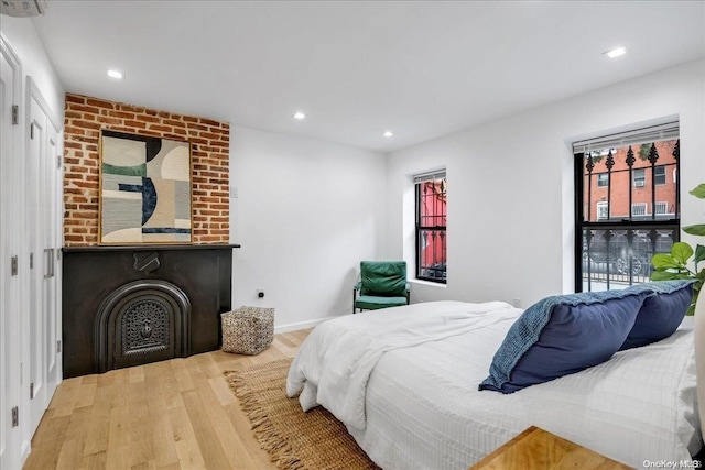 448 Halsey St, Stuyvesant Hts, NY 11233 - bedroom with wood finished floors, recessed lighting, and a fireplace