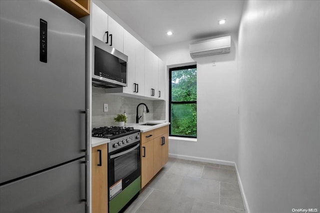 kitchen with backsplash, white cabinets, sink, appliances with stainless steel finishes, and a wall mounted AC