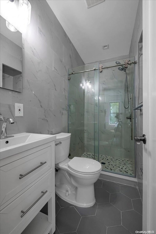 448 Halsey St, Stuyvesant Hts, NY 11233 - full bathroom with tile walls, a marble finish shower, vanity, and tile patterned floors